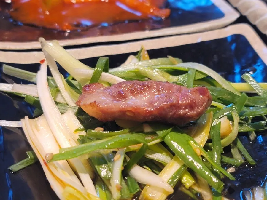 White kimchi arranged around the edge of the grill