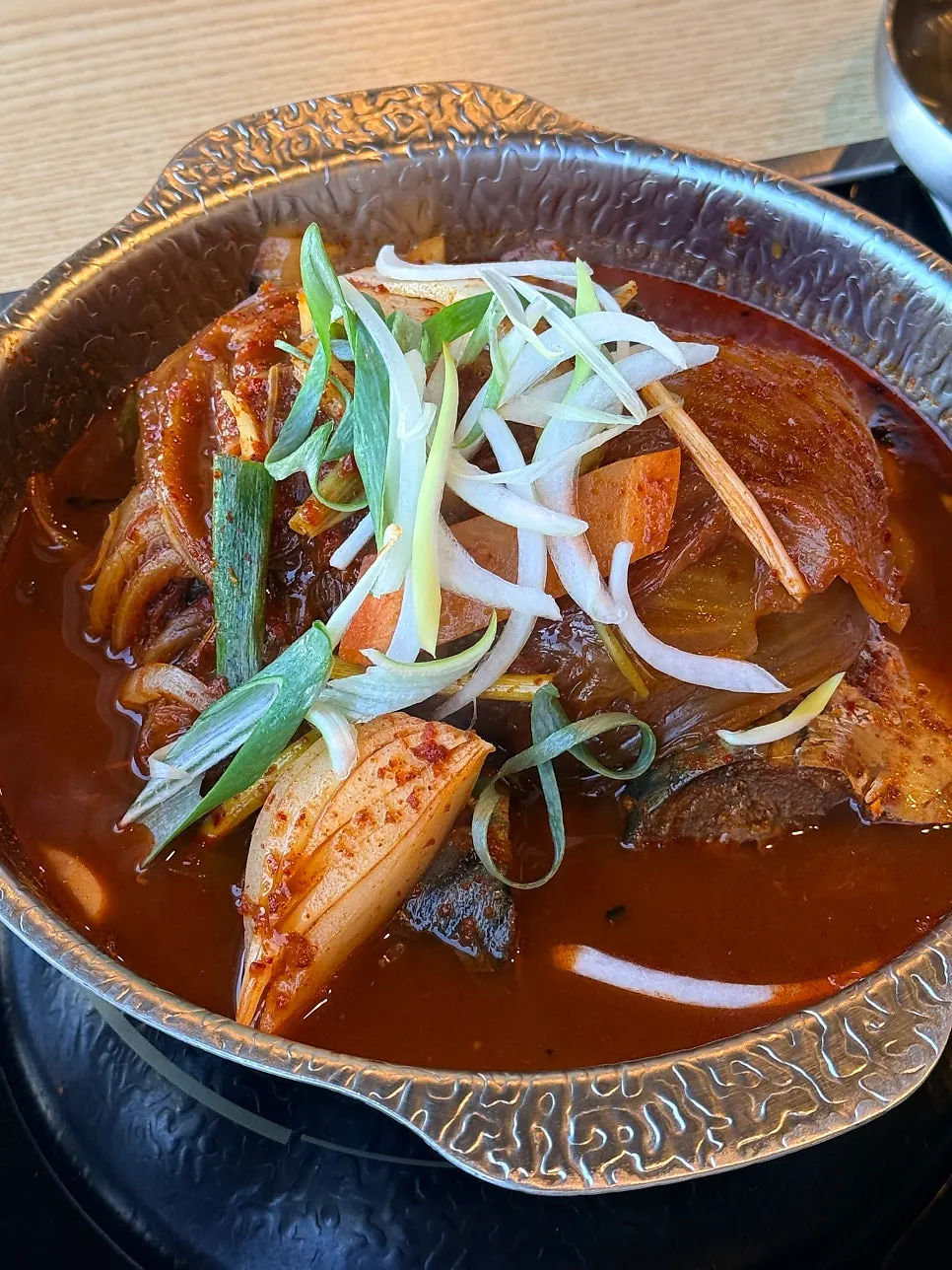 Mackerel and aged kimchi placed on a wrap vegetable