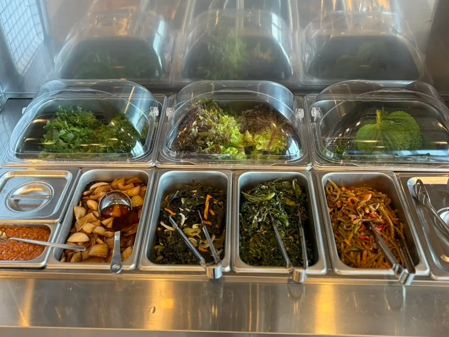 Various side dishes laid out at the self-serve bar