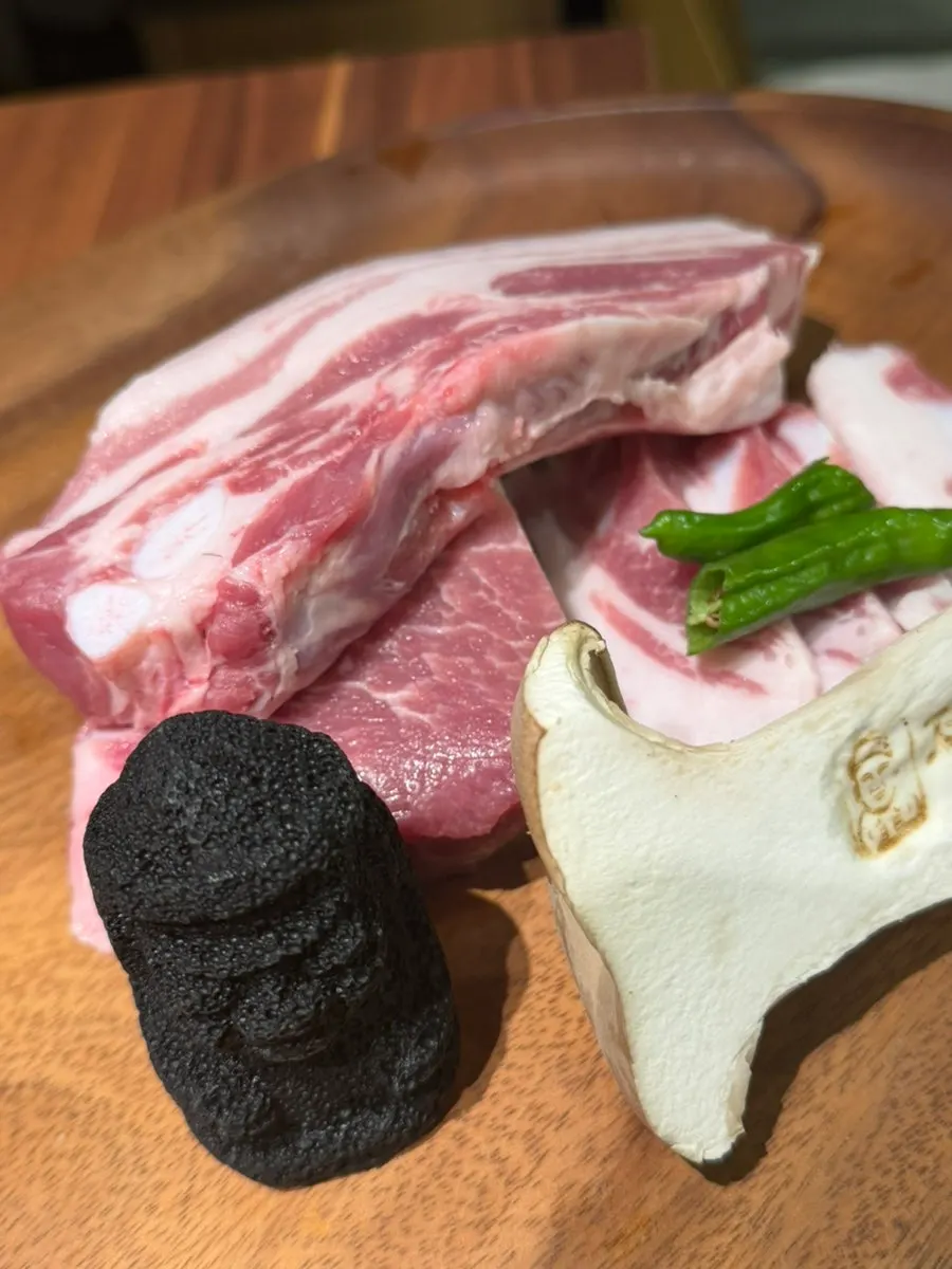 Staff grilling smoked black pork