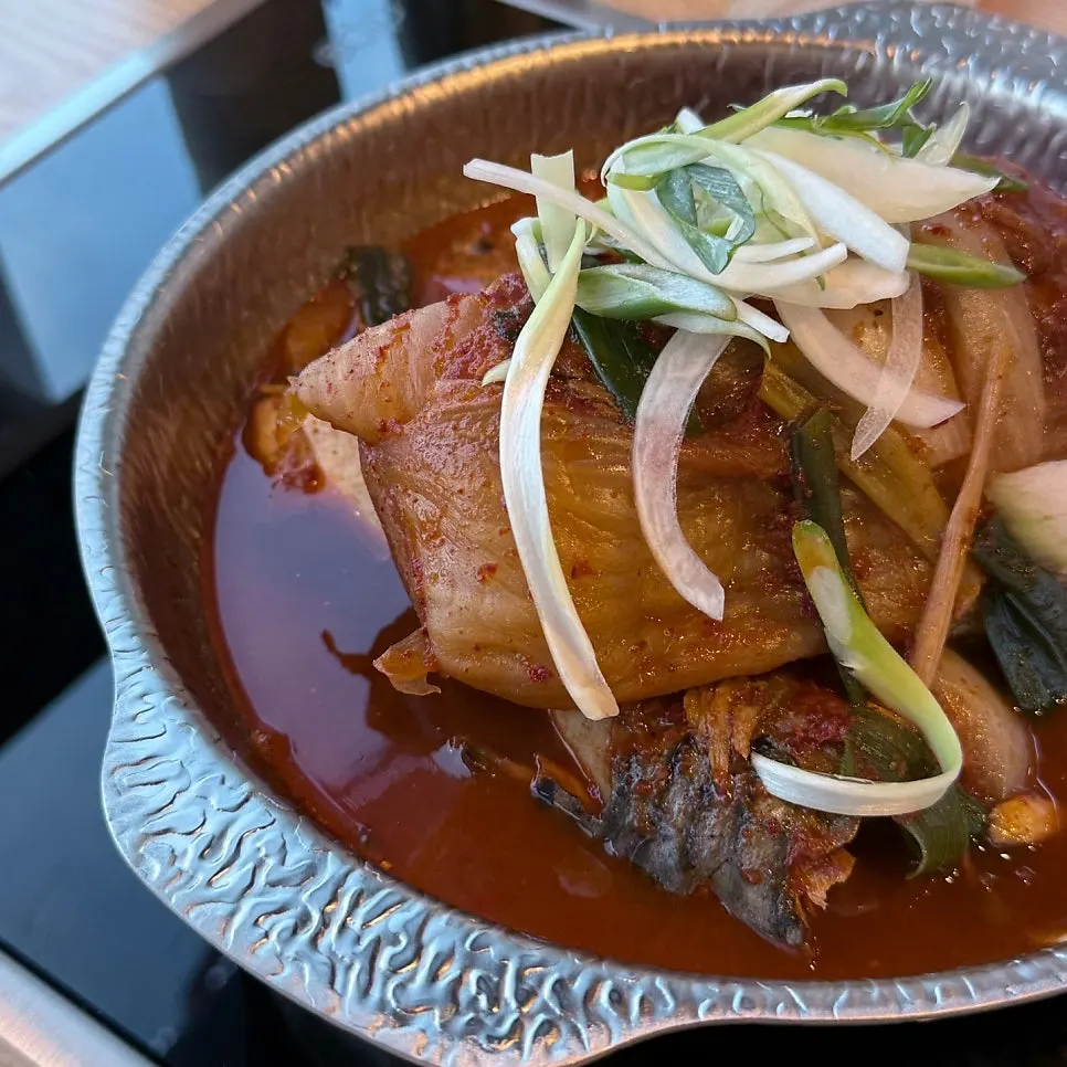 Mackerel stew topped with a whole piece of aged kimchi