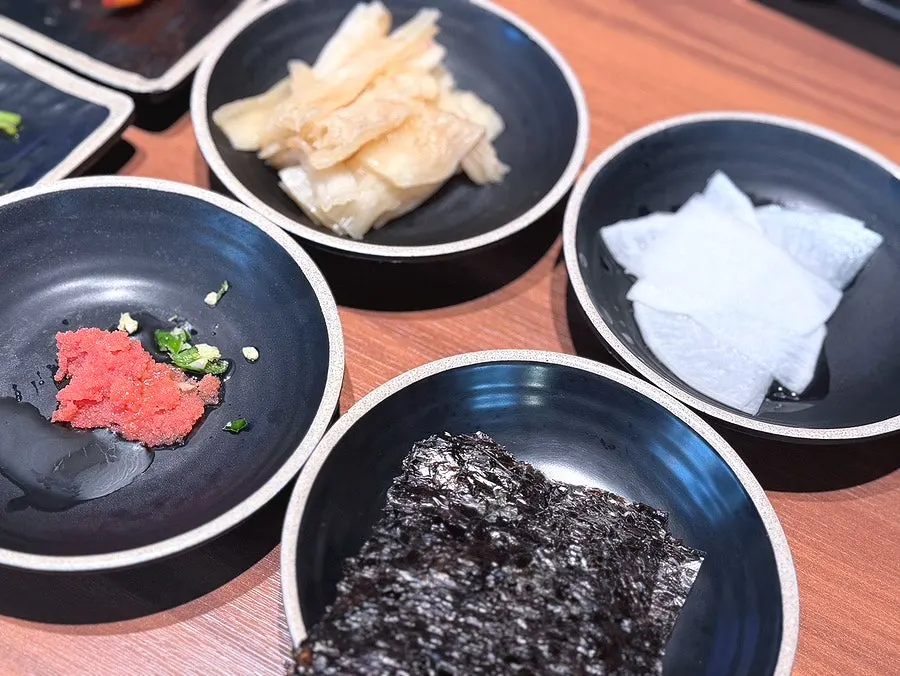 Cucumber kimchi, roasted seaweed, and sauce accompaniments