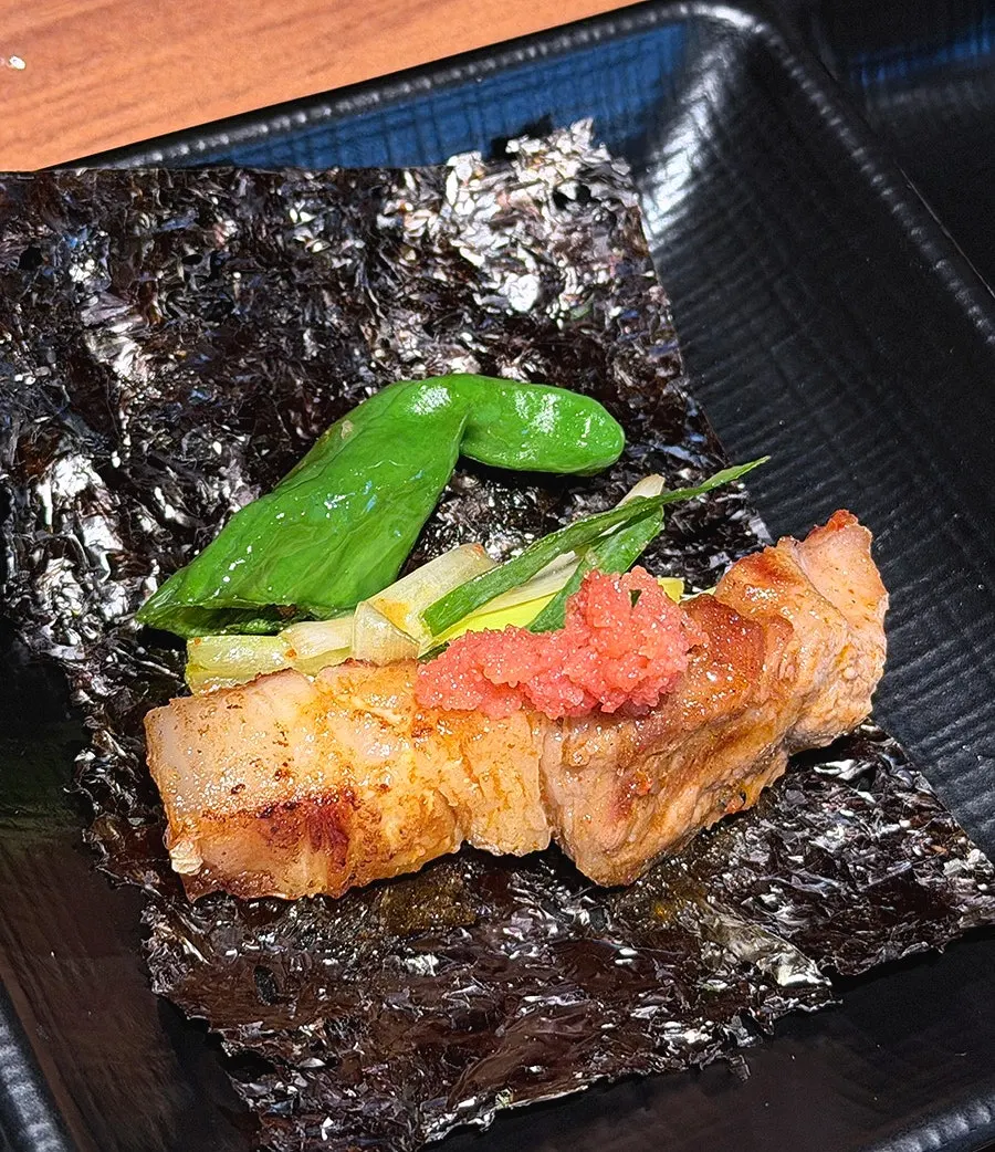 Aged kimchi grilling around the edge of the grill