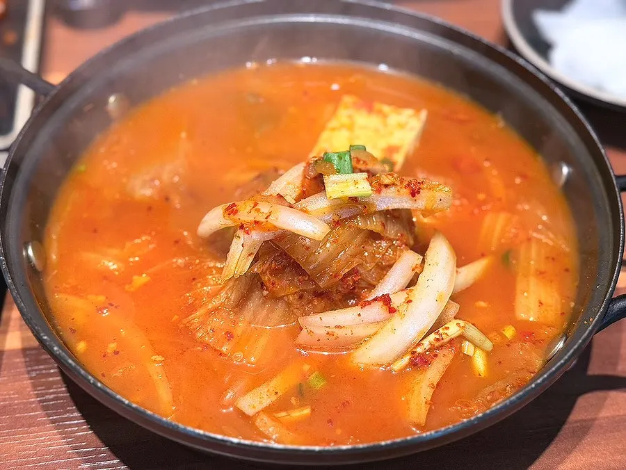 Kimchi stew eaten with a bowl of rice