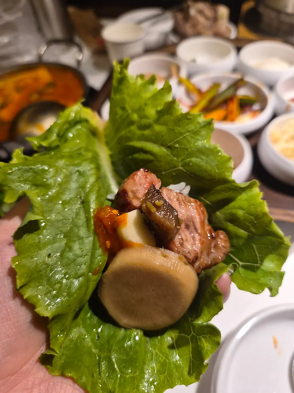 Fully cooked pork neck set aside on the grill