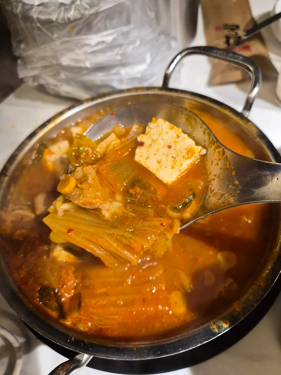 Kimchi jjigae topped with whole tofu