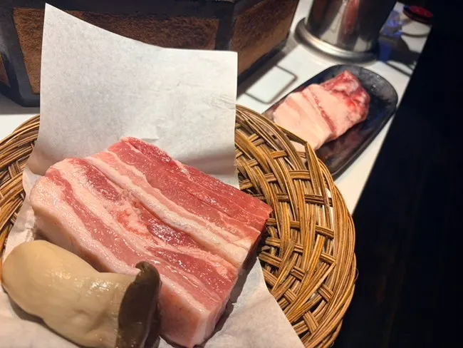 A tray of pre-grilled aged pork belly