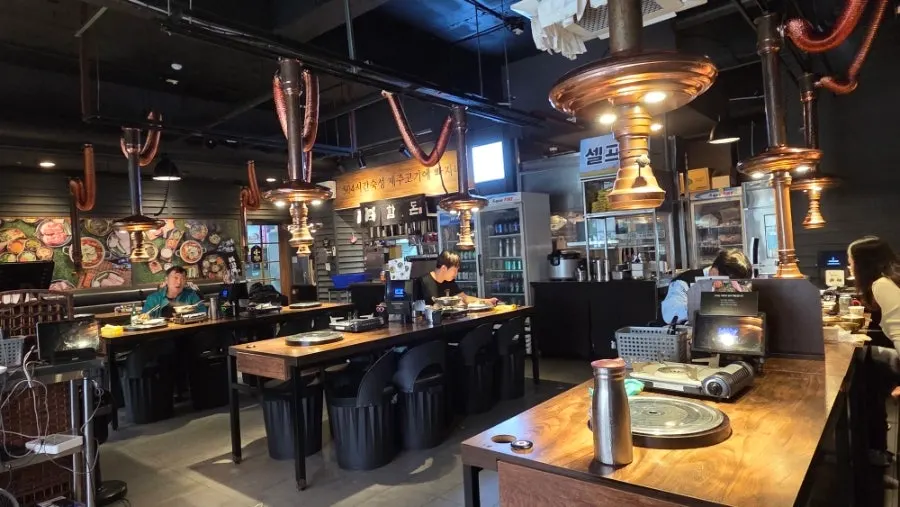 Interior of Hamdon with black walls and wood tables