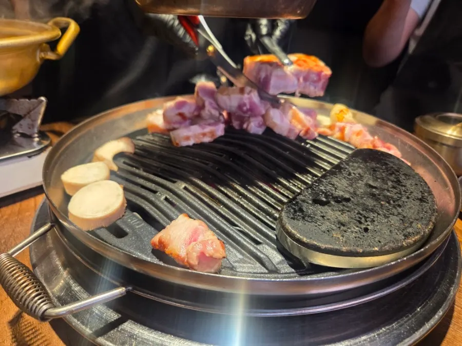 Grill full of sliced pork belly pieces