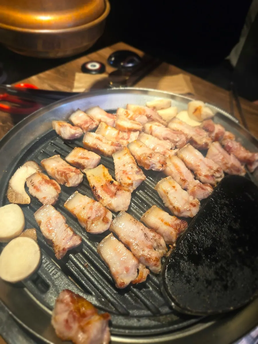 Grilled pork belly and king oyster mushrooms together on the grill