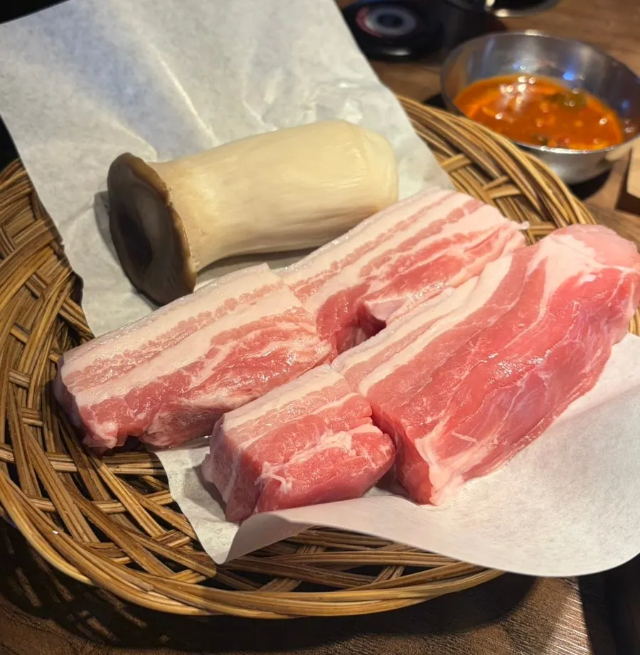 Two servings of aged pork belly served in a basket