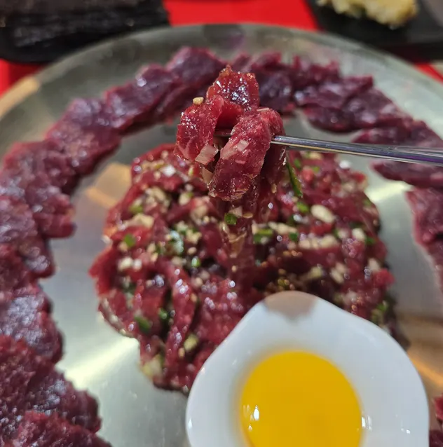Yukhoe mixed with the broken egg yolk