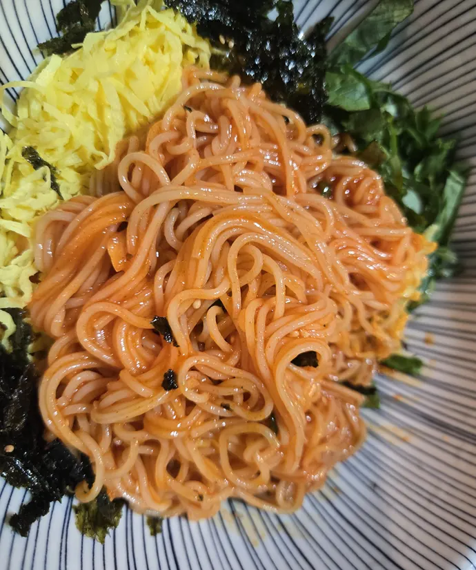 Complimentary bibim guksu (spicy mixed noodles)