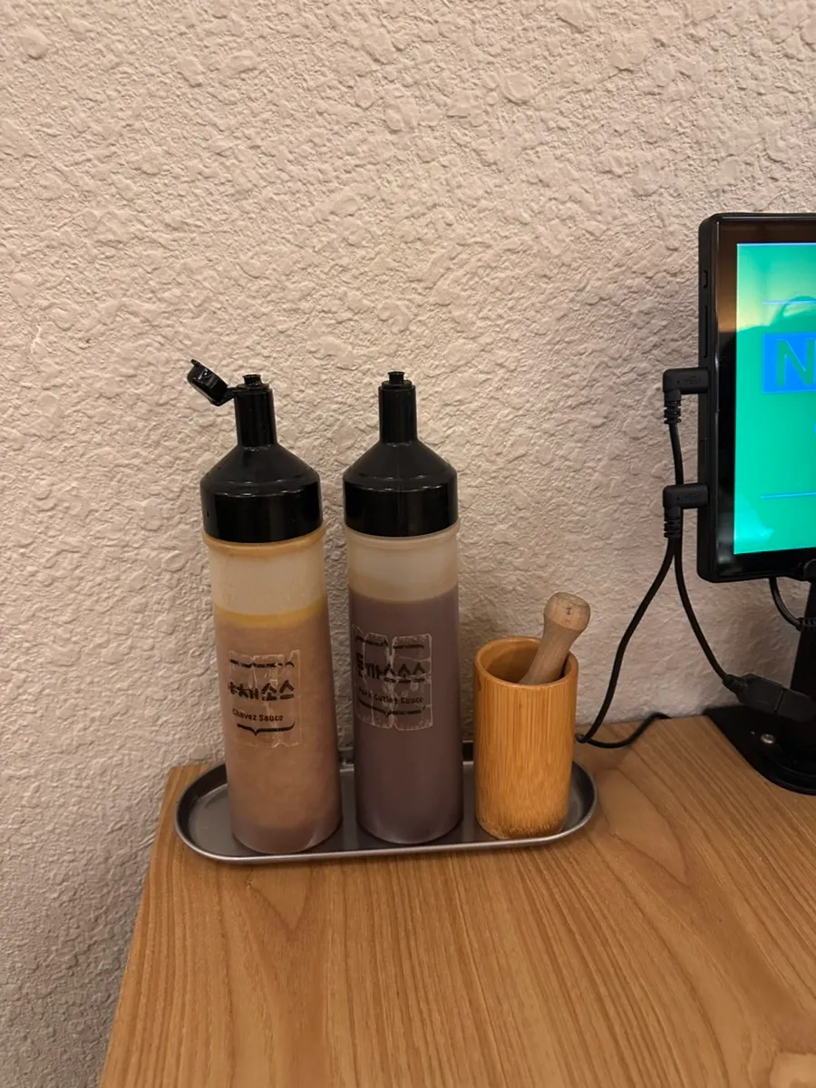 Tonkatsu sauce and salad sauce beside the table