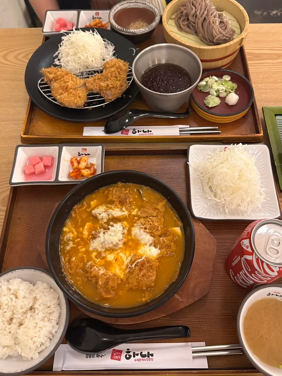 Table set with tonkatsu, soba, and nabe