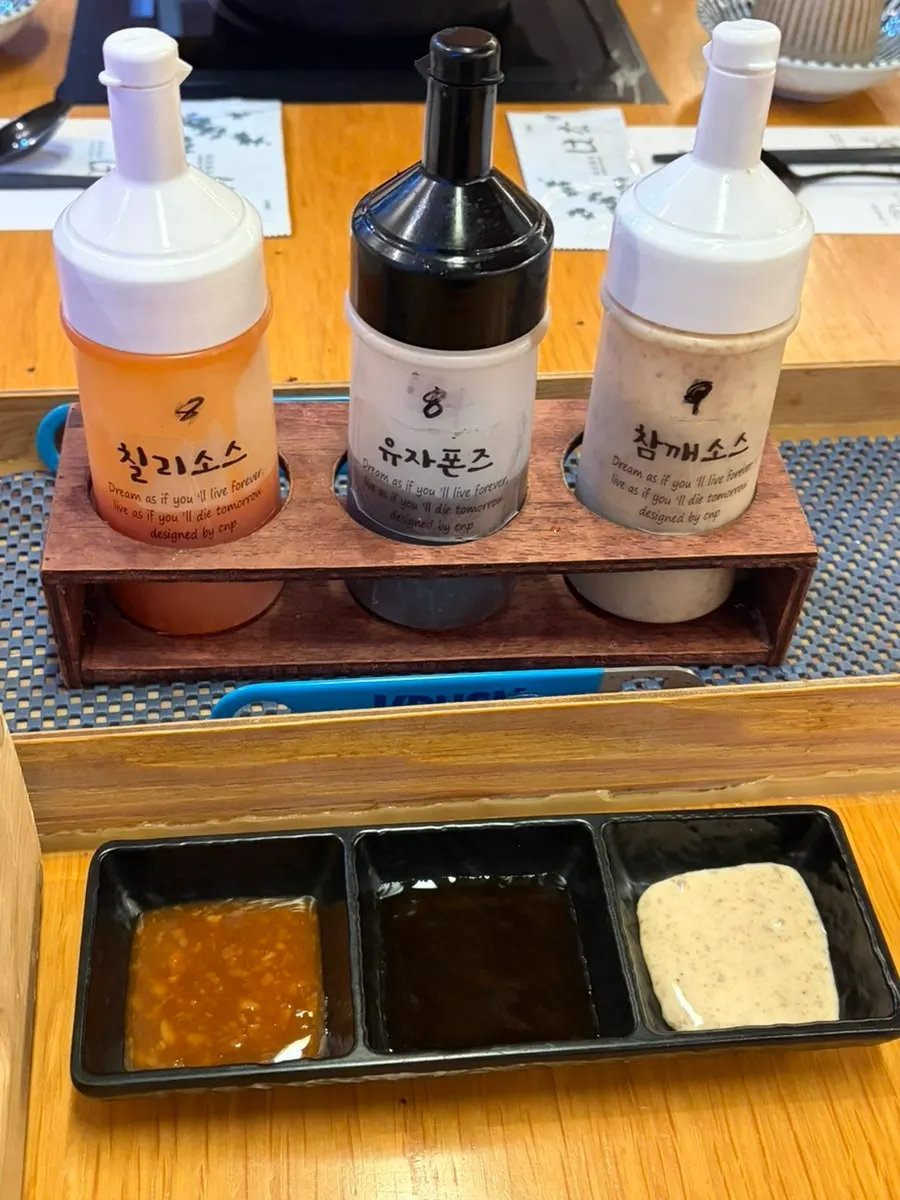 Three sauces: chili, yuzu ponzu, and sesame