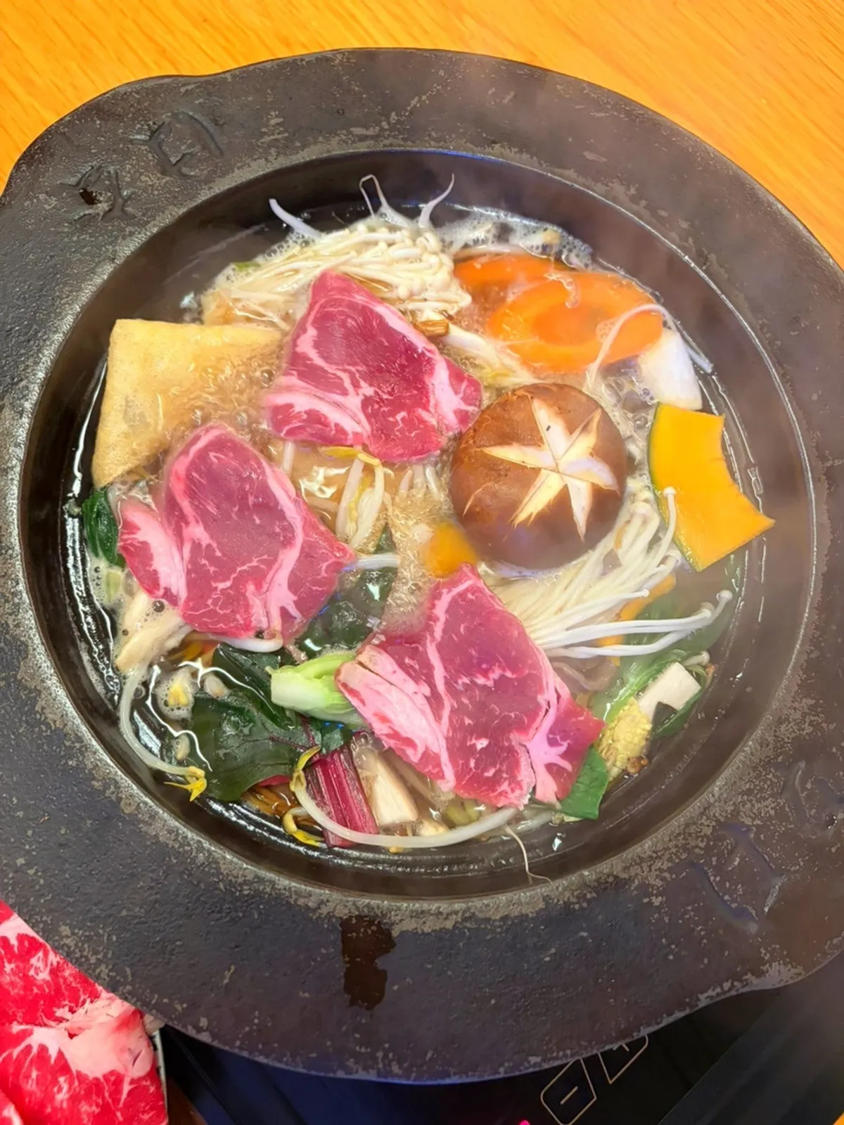Blanching black angus beef in the vegetable broth pot