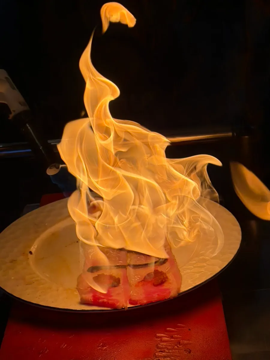 Torch flame performance for tadaki beside the table