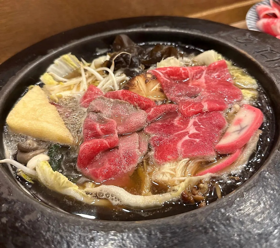 Dipping beef into the shabu-shabu pot