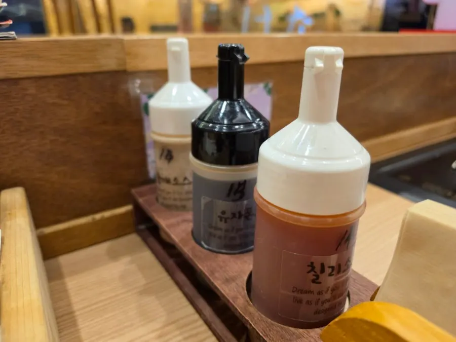 Three sauces: sweet chili, soy sauce, and sesame