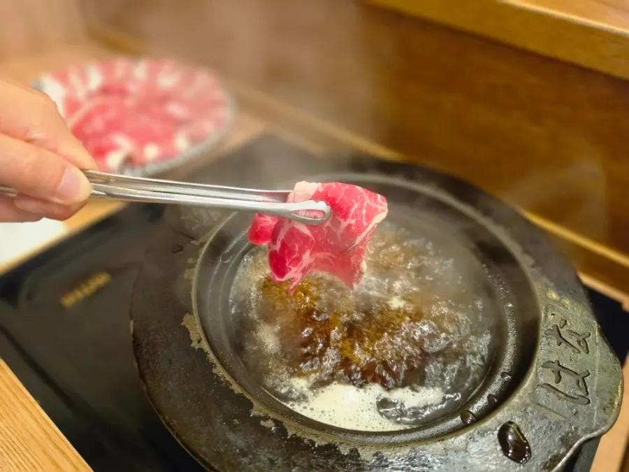 Shabu-shabu broth boiling in the cast-iron pot