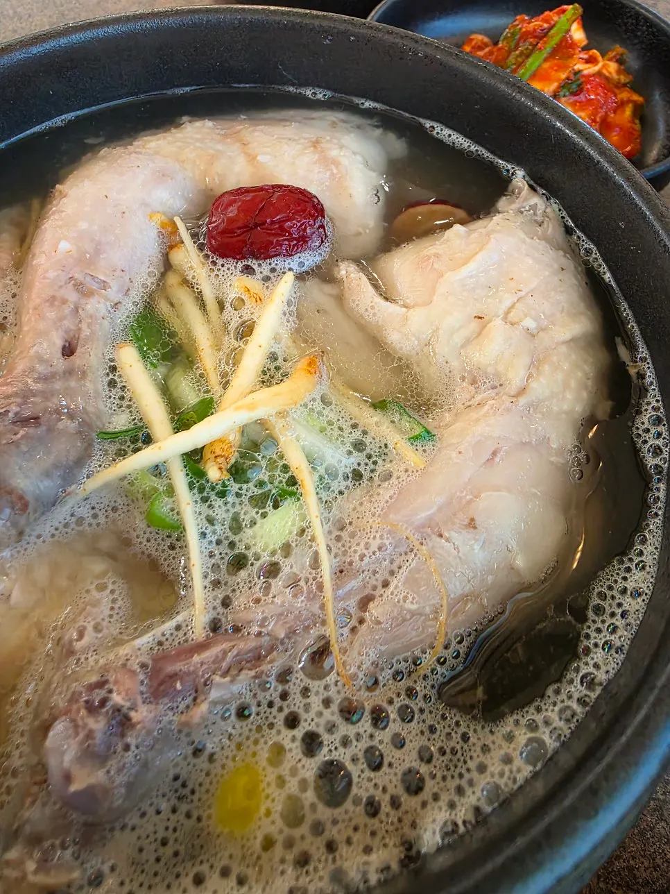 Ladle scooping the transparent samgyetang broth