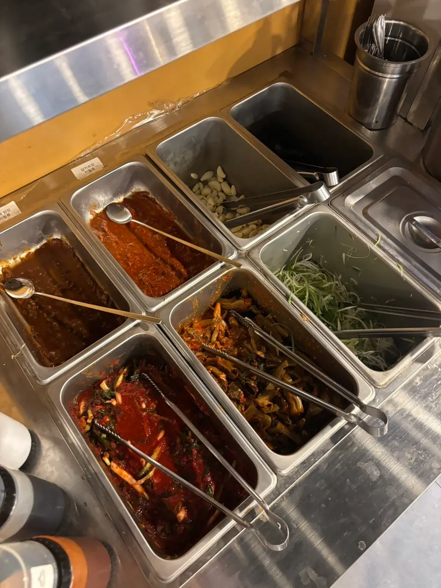 A plate of lettuce wraps and side dishes brought from the self-serve bar
