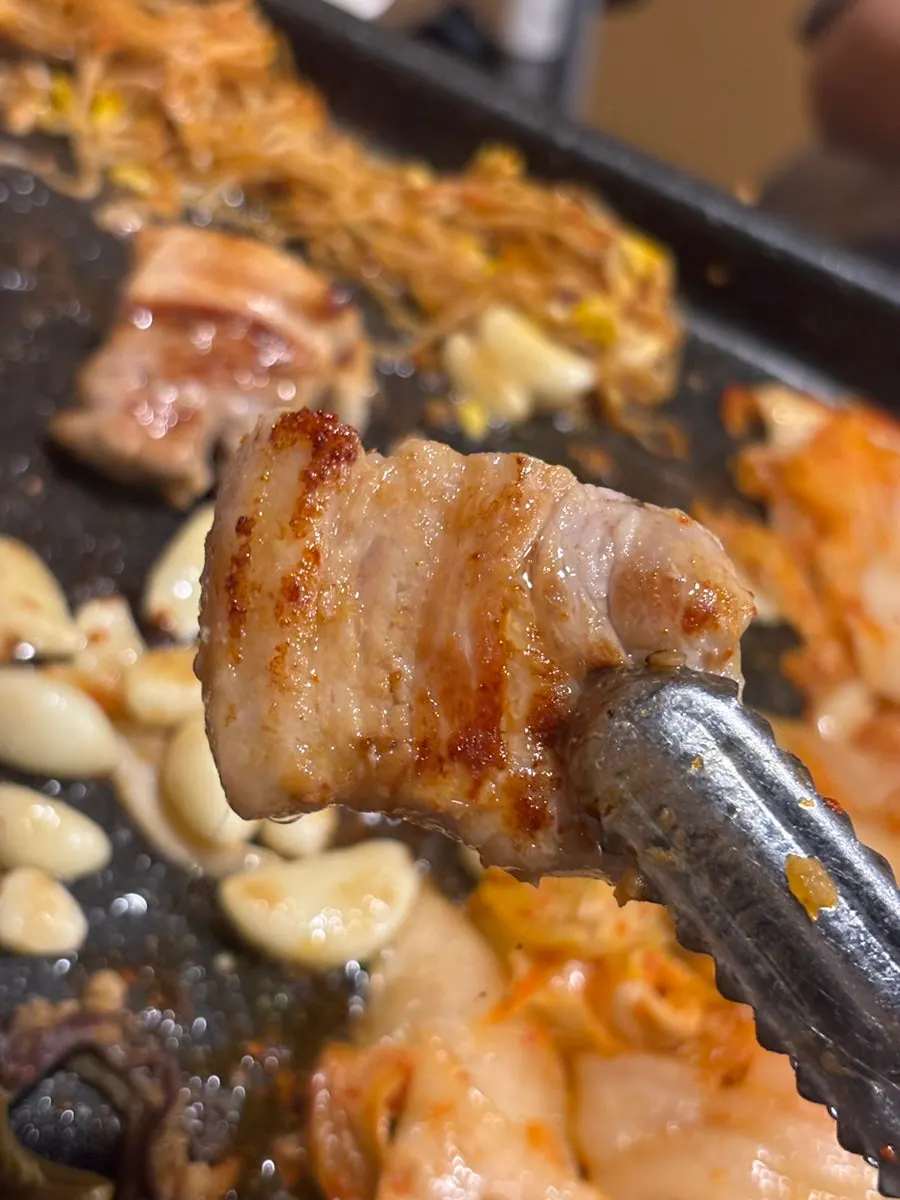 A plate combining grilled meat and kimchi