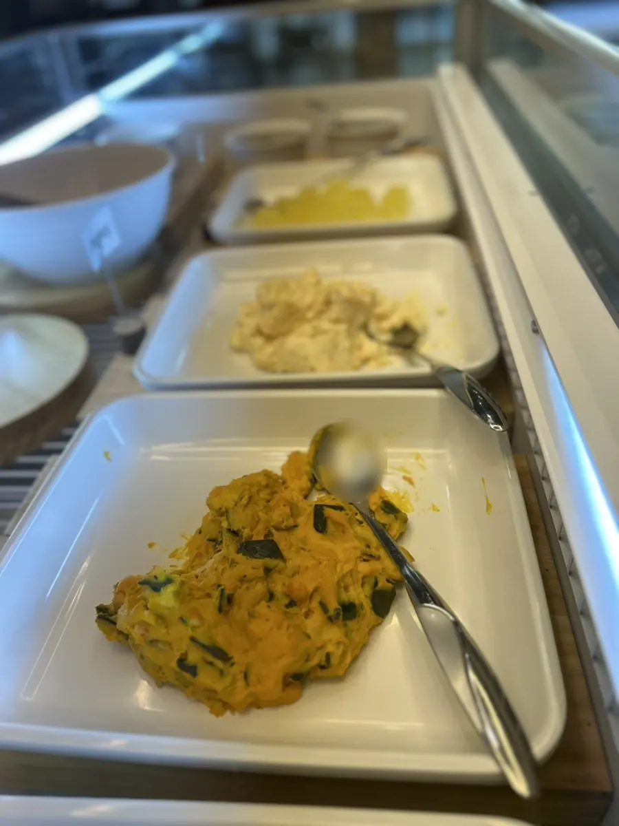 Salad bar corner with warm soup and tteokbokki