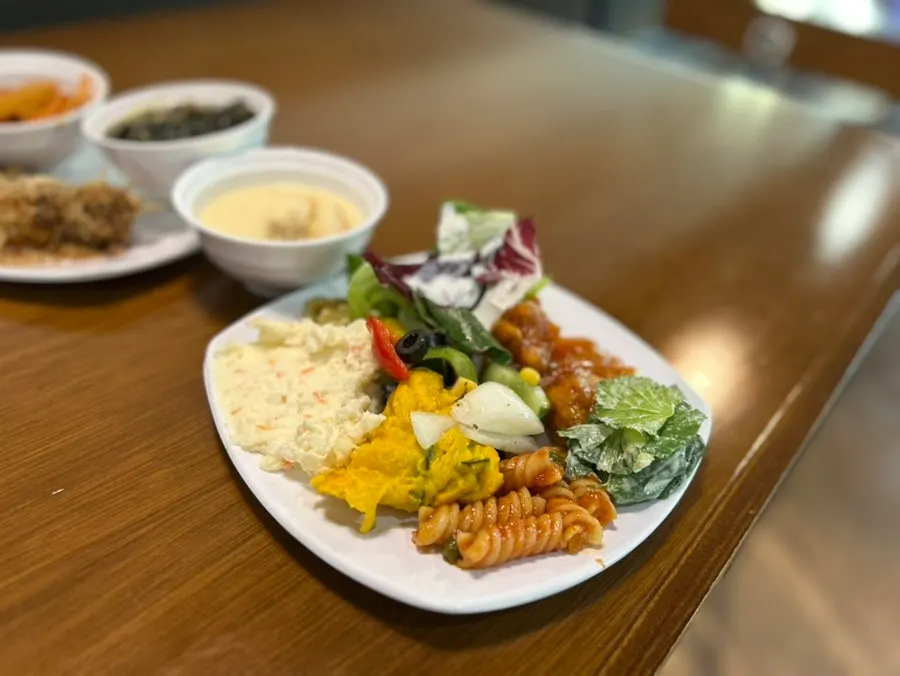 A plate with salad greens from the salad bar