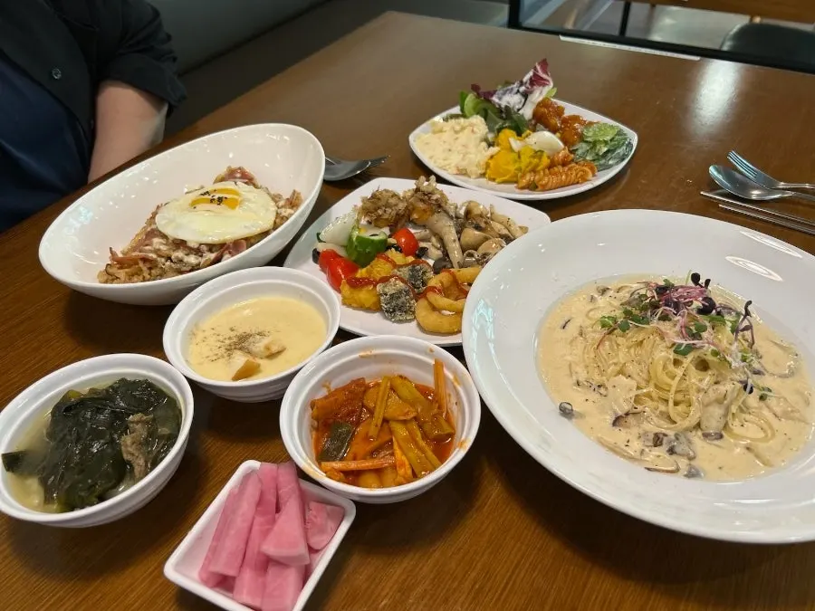 Table setting with Fungi cream pasta and bacon pilaf
