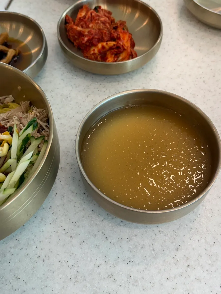 Dongchimi bibim noodles topped with finely chopped pork