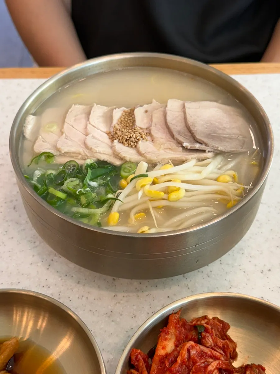 Noodles and pork lifted up with chopsticks