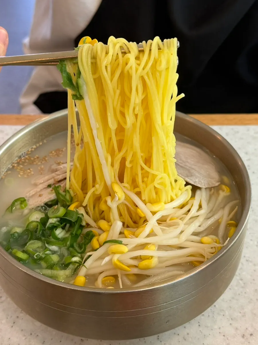 Bone-broth pork noodle soup topped with boiled pork and bean sprouts