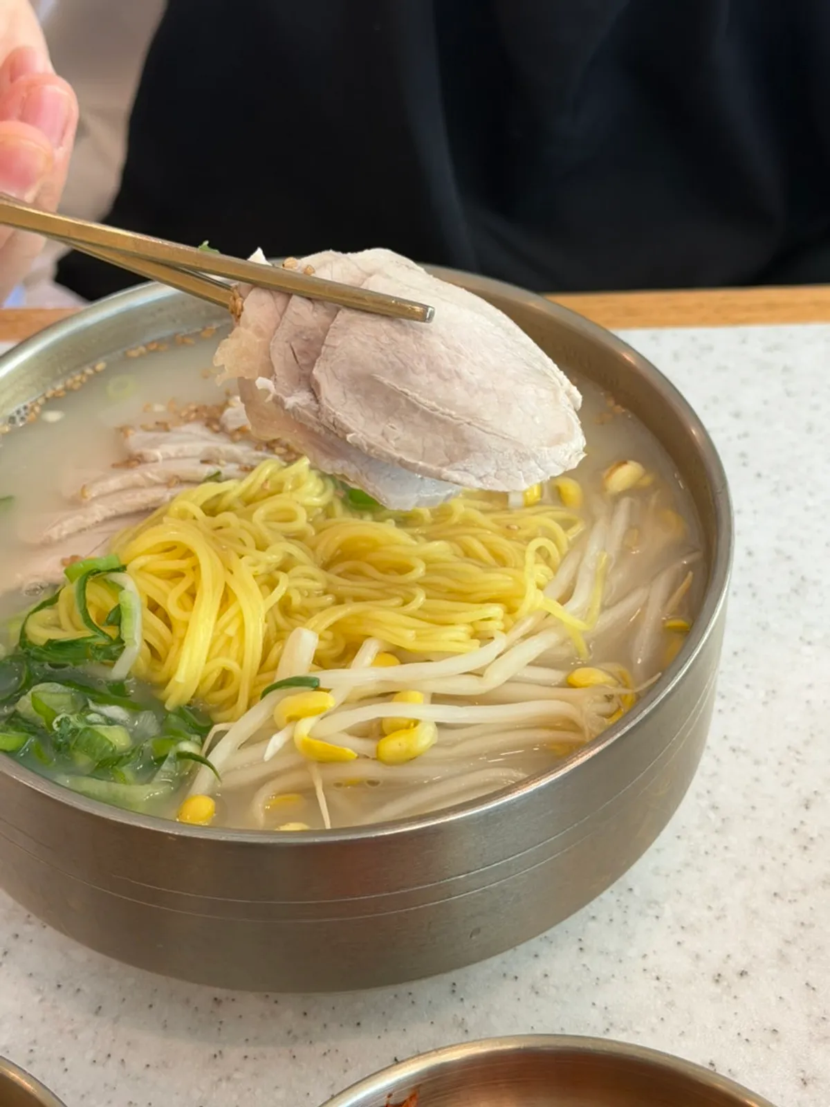 Handam Guksu's bone-broth pork noodle soup with a generous boiled pork topping