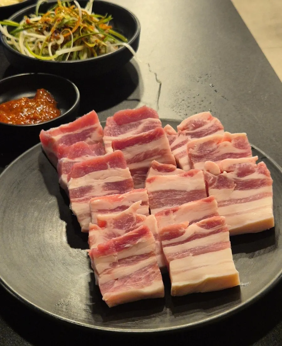 Pork belly sizzling on the griddle