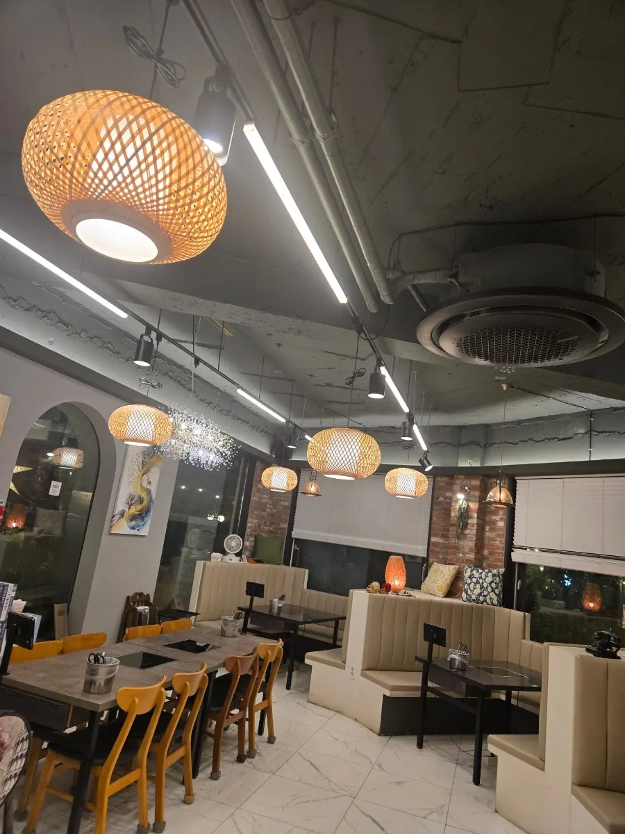 Interior atmosphere with tables and lighting visible