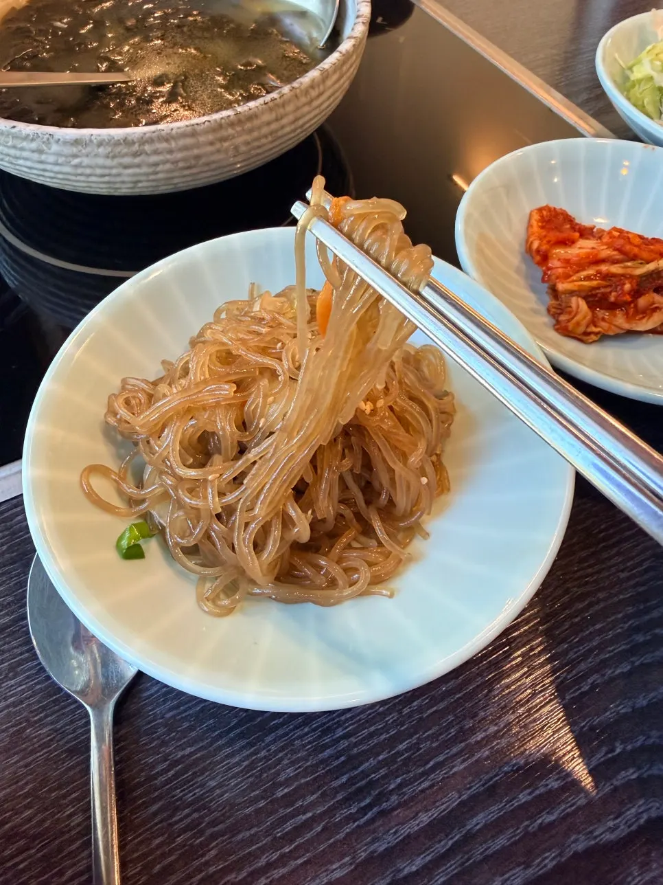 Side dishes including japchae and salad