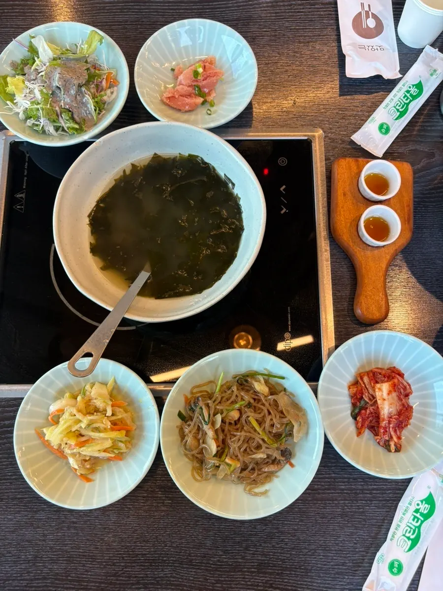Side dish spread with japchae and seaweed soup