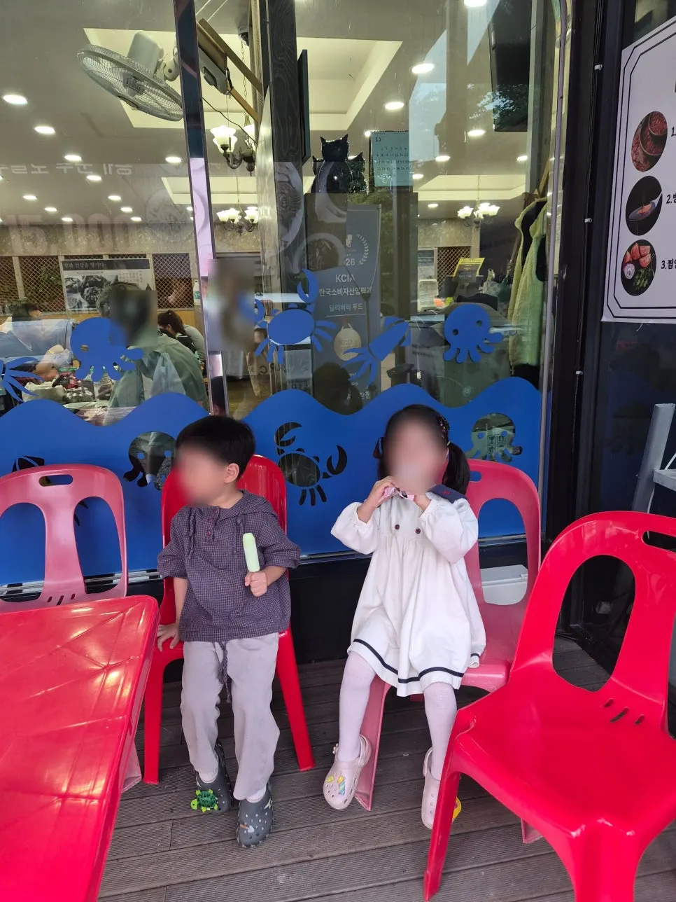 Twins sitting outside the restaurant after their meal