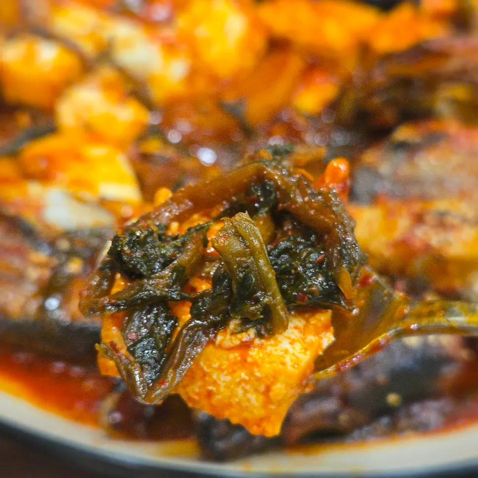 Radish greens and tofu inside the braised pollock