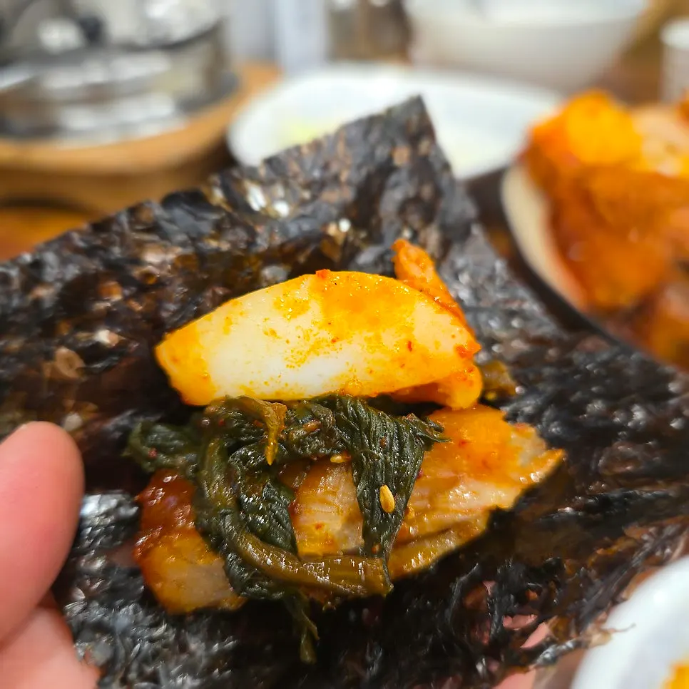 A bite of pollock and cuttlefish on dried seaweed