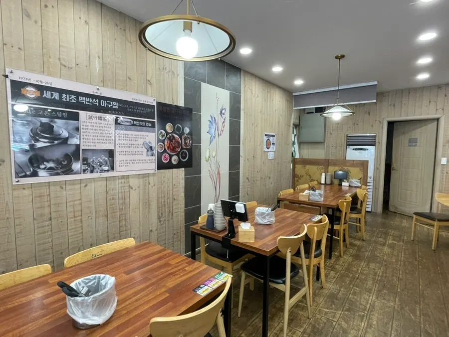 우드톤 테이블이 놓인 아빠찜 하남본점 홀