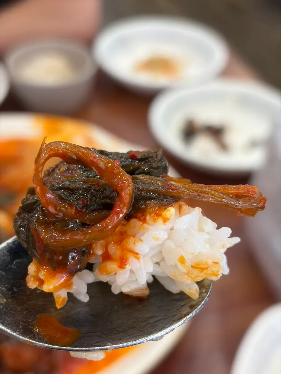 A wrapped bite of pollock in a lettuce wrap