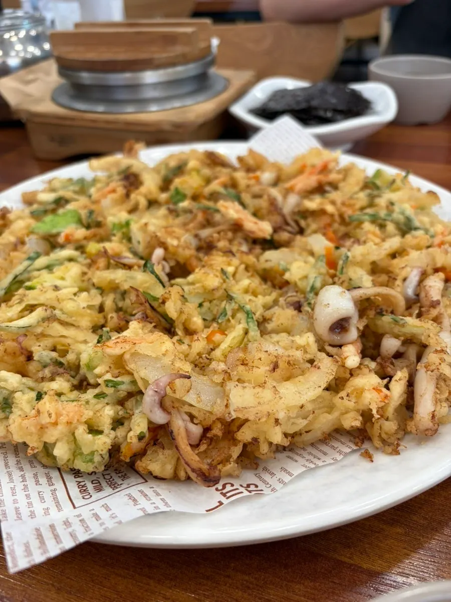 A large serving of crispy seafood pancake