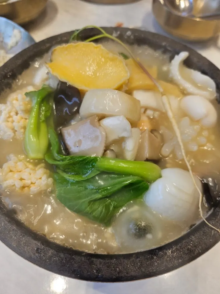 Close-up of the rice soup packed with abalone and seafood