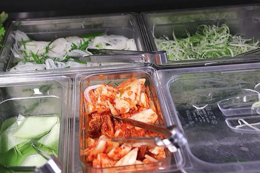Sauces, sesame oil, and salt at the self-serve corner