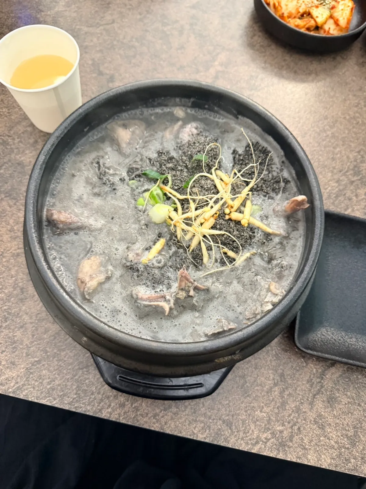 A full serving of black sesame samgyetang at Baekheukdam