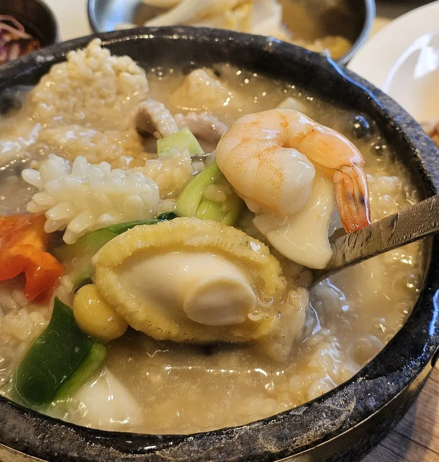 A bubbling hot bowl of seafood abalone nurungjitang