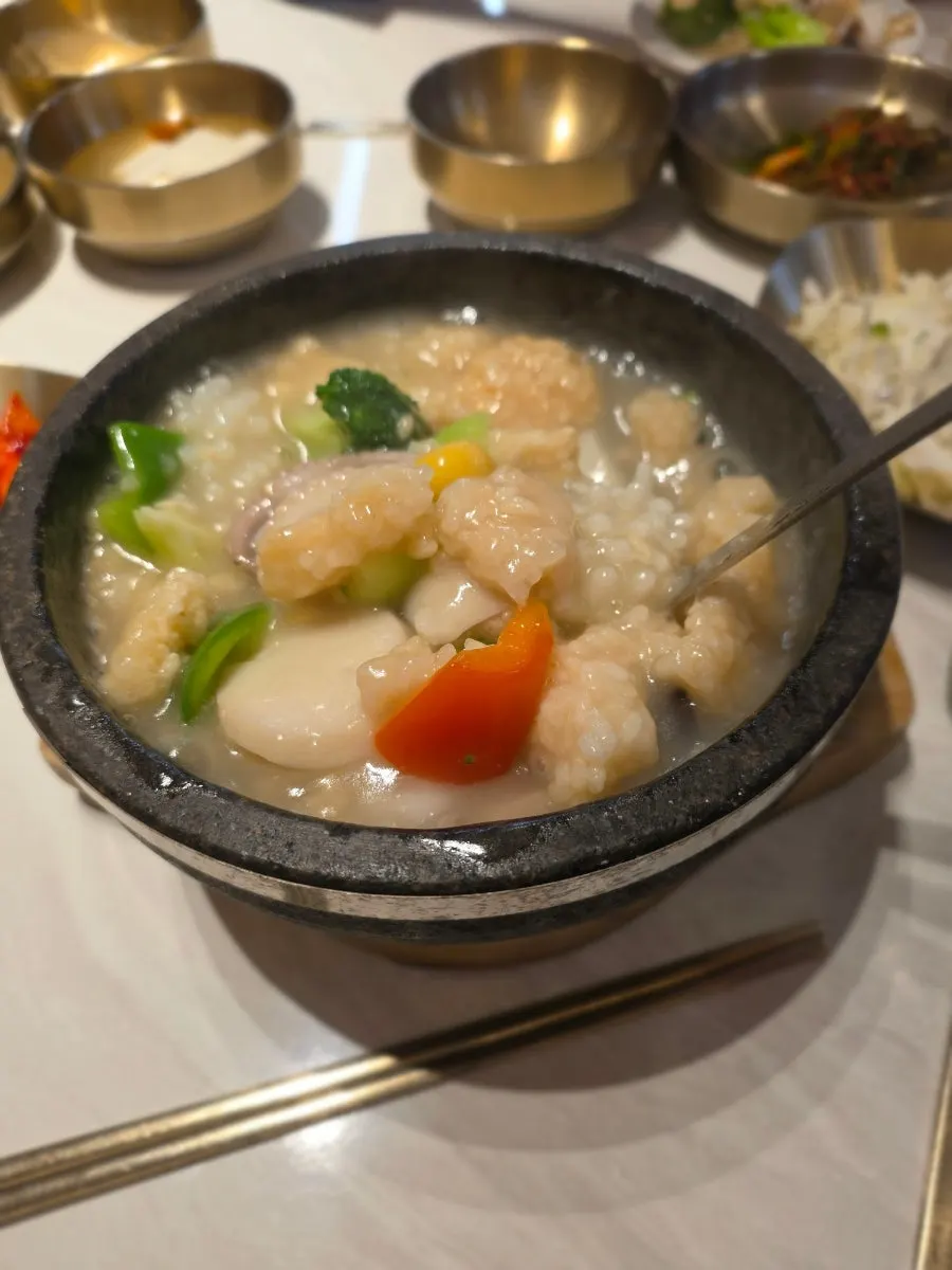 Shrimp and squid visible in the scorched rice soup